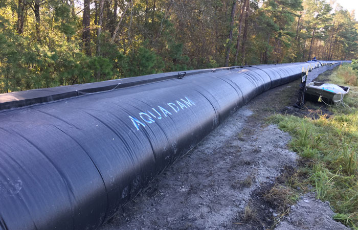 Santee Cooper deploys an AquaDam around Grainger’s Ash Pond 2, which will add 30 inches to the height of the dike and help protect the pond from flood waters.