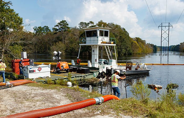 Supplies are shipped in via barges as many areas around the Grainger ash ponds are covered in water from rising river levels.