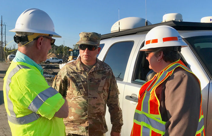 Santee Cooper Interim President and CEO Jim Brogdon discusses ash pond mitigation efforts with Army National Guard Major General Robert E. Livingston Jr. and S.C. Secretary of Transportation Christy Hall.