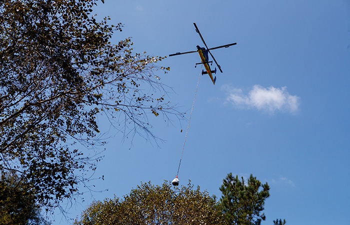 A heavy lift helicopter carries sandbags to ash pond 2 in an effort to shore up the banks of the Grainger ash ponds before river levels rise as a result of flooding caused by Hurricane Florence  Friday, Sept. 21, 2018 in Conway.