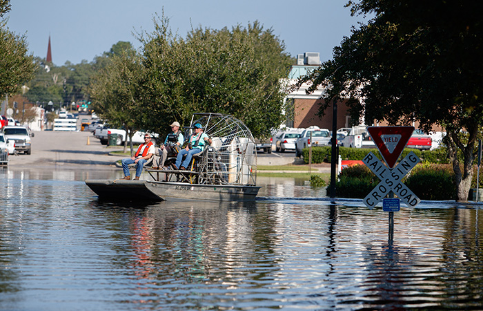 Water flows over the road at the Conway Marina as river levels rise as a result of flooding caused by Hurricane Florence Friday, Sept. 21, 2018 in Conway.