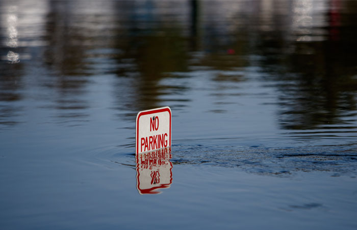 Water flows over the road at the Conway Marina as river levels rise as a result of flooding caused by Hurricane Florence Friday, Sept. 21, 2018 in Conway.