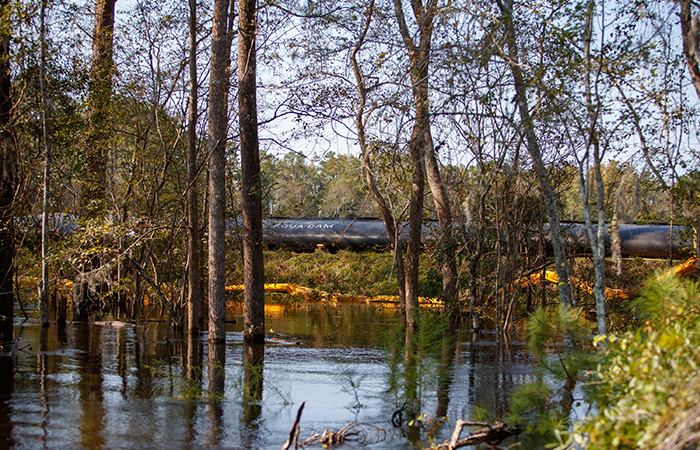 Crews work to shore up the banks of the Grainger ash ponds before river levels rise as a result of flooding caused by Hurricane Florence Friday, Sept. 21, 2018 in Conway.