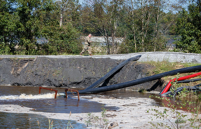 Water is pumped into Ash Pond 2 to equalize pressure on the dikes due to river levels rising as a result of flooding caused by Hurricane Florence.