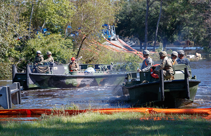 Members of the Army Corps of Engineers arrive to assist crews working to shore up the banks of the Grainger ash ponds before river levels rise as a result of flooding caused by Hurricane Florence.