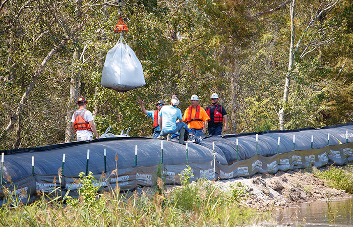 A heavy lift helicopter carries sandbags to ash pond 2 in an effort to shore up the banks of the Grainger ash ponds before river levels rise as a result of flooding caused by Hurricane Florence  Friday, Sept. 21, 2018 in Conway. 