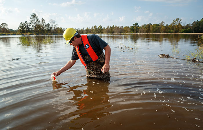 Water samples are taken in Grainger Ash Pond 1 as river water levels top the dike of the pond. Saturday, Sept. 22, 2018 in Conway.