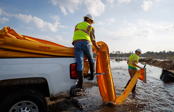 Crews deploy floating boom on Grainger Ash Pond 1 as river levels rise as a result of flooding caused by Hurricane Florence. Saturday, Sept. 22, 2018 in Conway.