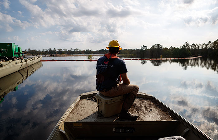 Crews work to shore up the banks of the Grainger ash ponds as river levels rise as a result of flooding caused by Hurricane Florence. Saturday, Sept. 22, 2018 in Conway. 