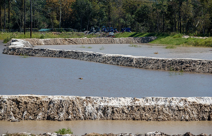 A series of dikes are put into place and water is pumped into the ash ponds to protect them from  rising river levels as a result of flooding caused by Hurricane Florence.