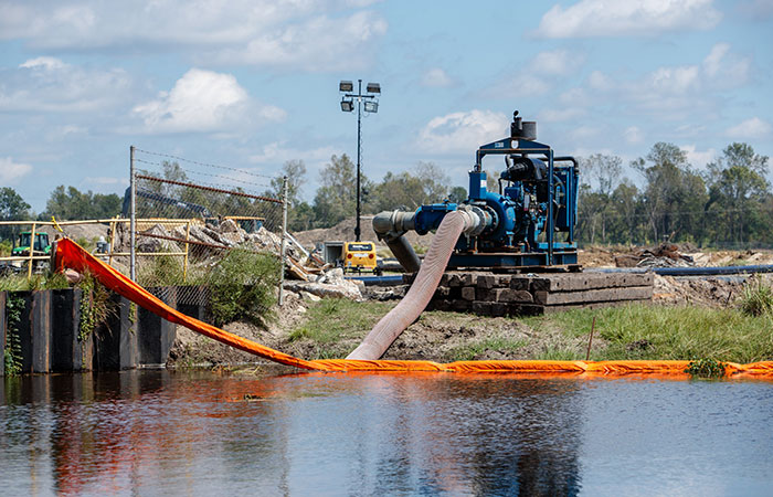 A series of dikes are put into place and water is pumped into the ash ponds to protect them from  rising river levels as a result of flooding caused by Hurricane Florence.