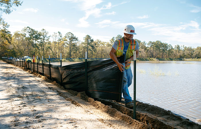 Crews with Palmetto Corp. work to protect the banks of the Grainger Ash Pond 2 with silt fencing before river levels rise as a result of flooding caused by Hurricane Florence.