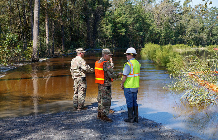 Santee Cooper crews work with the Army Corps of Engineers on the Grainger ash ponds before river levels rise as a result of flooding caused by Hurricane Florence.