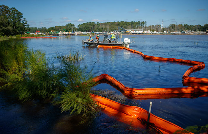 Santee Cooper crews deploy floating booms around the banks of the Grainger ash ponds.