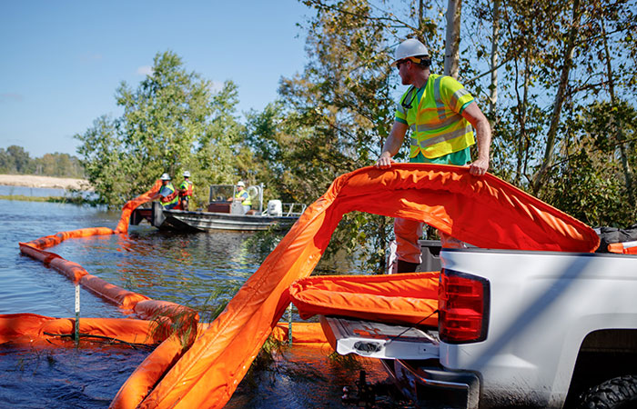 Santee Cooper crews deploy floating booms around the banks of the Grainger ash ponds.