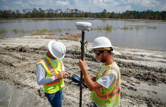 Crews check elevations as they shore up the banks of the Grainger ash ponds before the Waccamaw River reaches projected record heights.