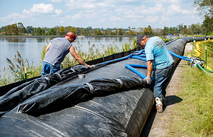 The AquaDam is filled with water by contract crews. The 6,000 feet of AquaDam surrounds Pond 2, adding 30 inches to the top of the dike.