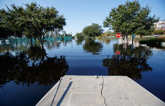 Water flows over the road at the Conway Marina as river levels rise as a result of flooding caused by Hurricane Florence Friday, Sept. 21, 2018 in Conway.